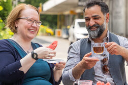 Two people are sitting an drinking tea