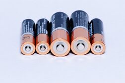 Black and brown batteries on white background.